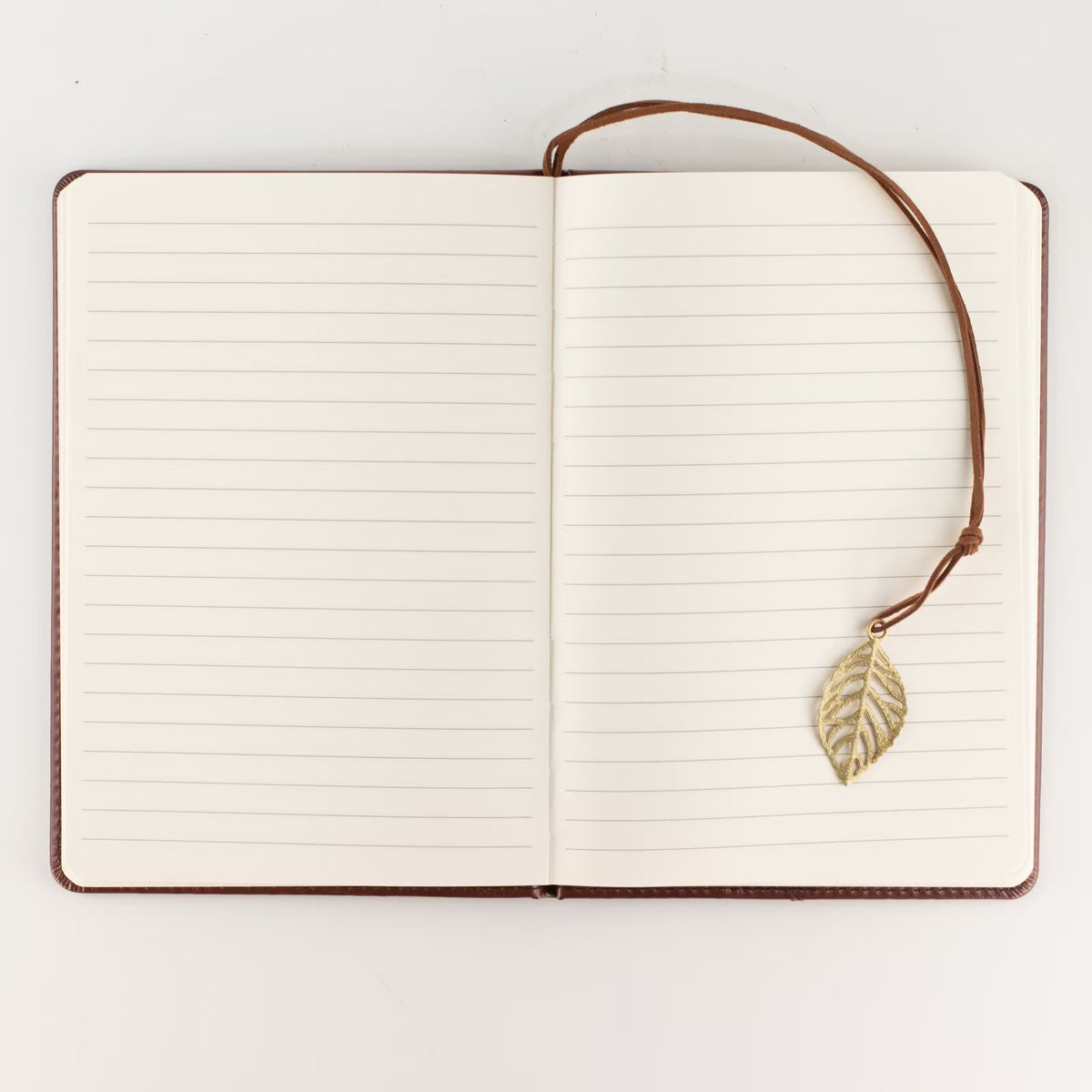 Jurnal A5 deschis, cu pagini liniate pentru notițe și semn de carte cu frunză decorativă